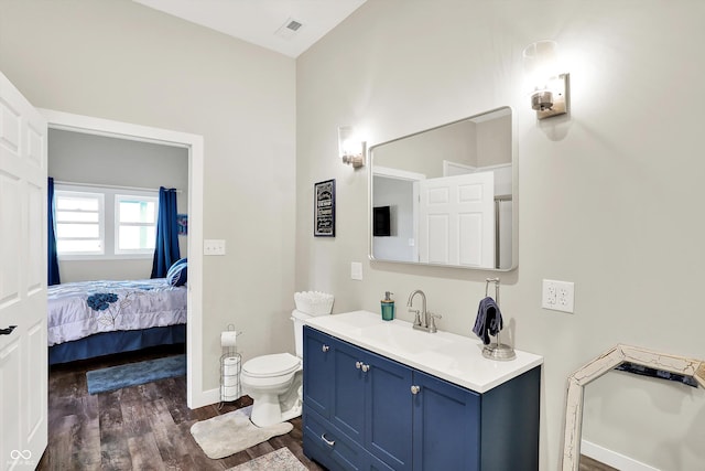 3301 N 200 W, Franklin, IN 46131 - bathroom featuring wood finished floors, vanity, toilet, baseboards, and connected bathroom