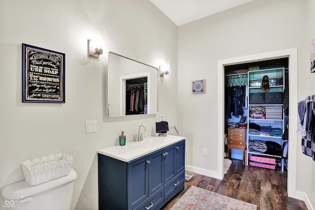 3301 N 200 W, Franklin, IN 46131 - bathroom with vanity, wood finished floors, toilet, a spacious closet, and baseboards