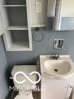 2028 Gilmore St, Columbus, IN 47201 - bathroom featuring tile walls and vanity