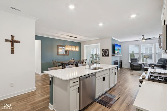 11429 Lottie Cir, Noblesville, IN 46060 - kitchen featuring stainless steel dishwasher, a sink, open floor plan, light countertops, and recessed lighting