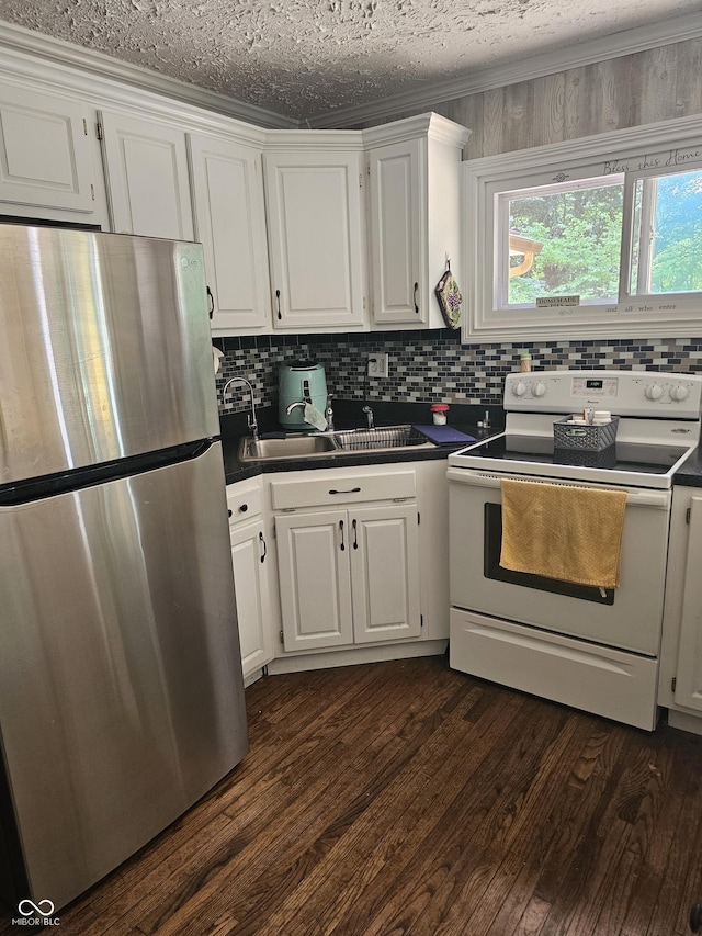 1317 S Ebert Dr, Rockville, IN 47872 - kitchen featuring freestanding refrigerator, white range with electric cooktop, dark countertops, and white cabinetry
