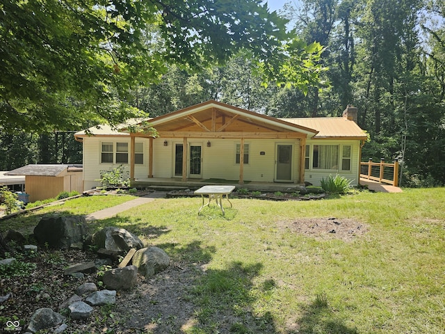 1317 S Ebert Dr, Rockville, IN 47872 - back of property with a chimney, a lawn, and a metal roof