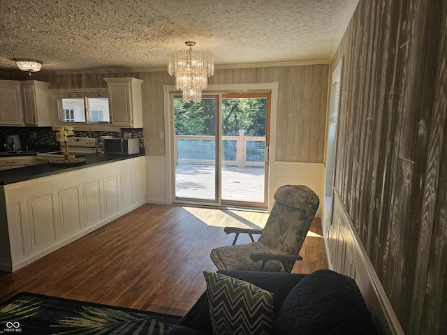 1317 S Ebert Dr, Rockville, IN 47872 - kitchen featuring stainless steel microwave, dark countertops, healthy amount of natural light, a chandelier, and ornamental molding