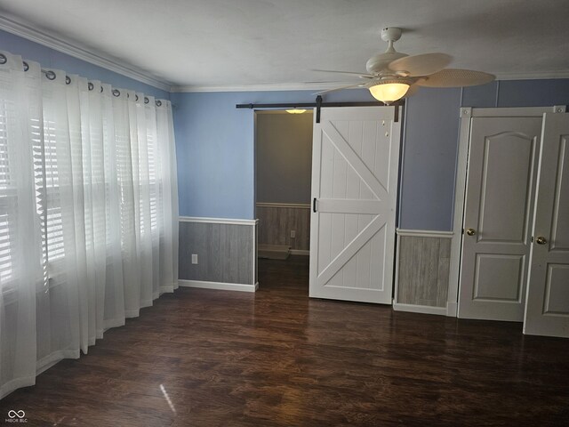 1317 S Ebert Dr, Rockville, IN 47872 - unfurnished bedroom with a wainscoted wall, a barn door, wood finished floors, ornamental molding, and ceiling fan