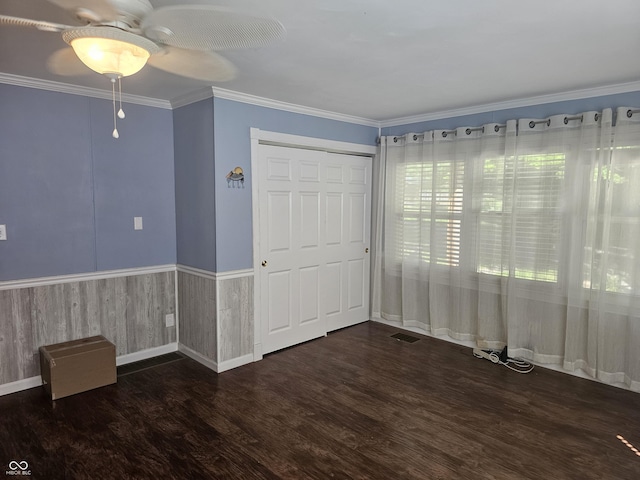 1317 S Ebert Dr, Rockville, IN 47872 - unfurnished bedroom with wood finished floors, ornamental molding, a ceiling fan, and a closet