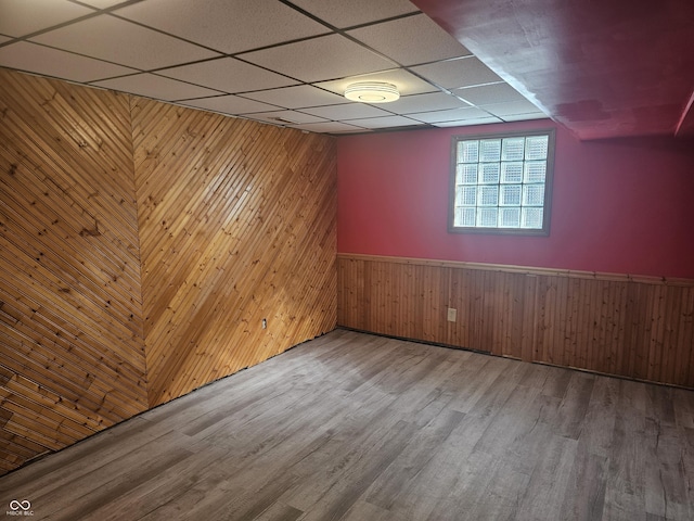 1317 S Ebert Dr, Rockville, IN 47872 - unfurnished room with wooden walls, wood finished floors, a drop ceiling, and wainscoting