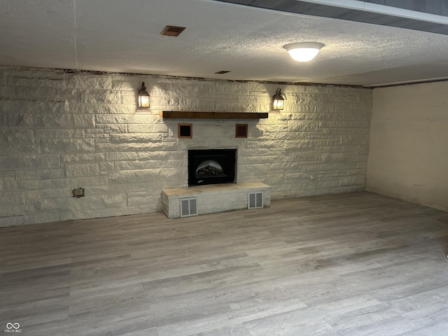 1317 S Ebert Dr, Rockville, IN 47872 - finished below grade area with a fireplace, wood finished floors, a textured ceiling, and concrete block wall