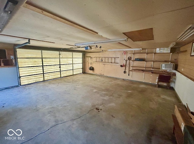3161 Normandy Rd, Indianapolis, IN 46222 - garage featuring a garage door opener and a wall mounted AC