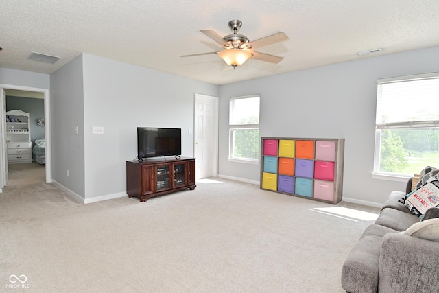 15524 Follow Dr, Noblesville, IN 46060 - living area with light colored carpet, a ceiling fan, baseboards, plenty of natural light, and a textured ceiling