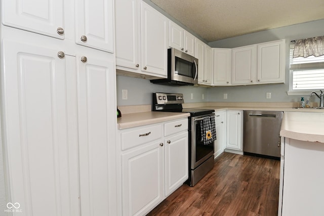 15524 Follow Dr, Noblesville, IN 46060 - kitchen with appliances with stainless steel finishes, dark wood-type flooring, white cabinetry, light countertops, and a sink