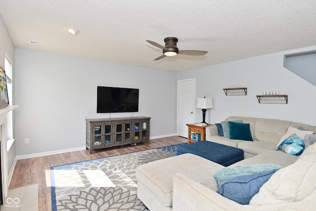 15524 Follow Dr, Noblesville, IN 46060 - living area with wood finished floors, a ceiling fan, a textured ceiling, and baseboards