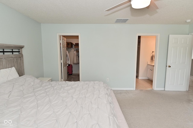 15524 Follow Dr, Noblesville, IN 46060 - bedroom featuring a spacious closet, carpet, a textured ceiling, ensuite bathroom, and a ceiling fan