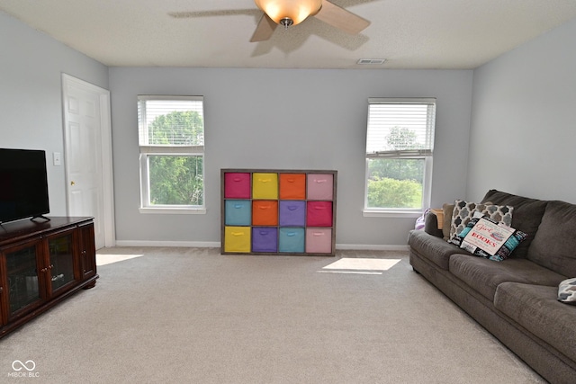 15524 Follow Dr, Noblesville, IN 46060 - carpeted living room featuring plenty of natural light, a ceiling fan, and baseboards