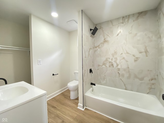 1429 Udell St, Indianapolis, IN 46208 - bathroom with toilet, wood finished floors, washtub / shower combination, vanity, and baseboards