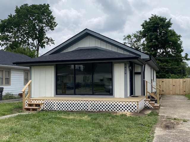 1429 Udell St, Indianapolis, IN 46208 - back of house with entry steps, a shingled roof, board and batten siding, and a sunroom
