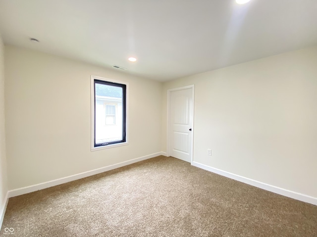 1429 Udell St, Indianapolis, IN 46208 - empty room featuring dark colored carpet, baseboards, and recessed lighting
