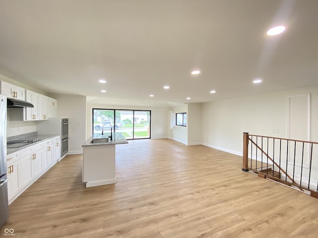 1429 Udell St, Indianapolis, IN 46208 - kitchen with under cabinet range hood, recessed lighting, stainless steel appliances, white cabinets, and light stone counters