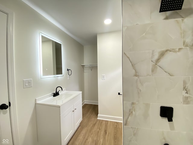 1429 Udell St, Indianapolis, IN 46208 - bathroom with vanity, baseboards, wood finished floors, tiled shower, and recessed lighting