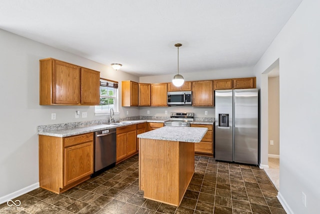 1739 Wedgewood Pl, Avon, IN 46123 - kitchen featuring appliances with stainless steel finishes, light countertops, brown cabinetry, a kitchen island, and hanging light fixtures