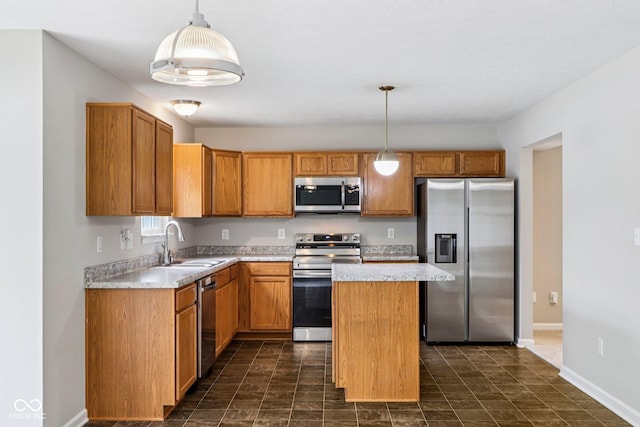 1739 Wedgewood Pl, Avon, IN 46123 - kitchen with appliances with stainless steel finishes, light countertops, a center island, decorative light fixtures, and brown cabinets