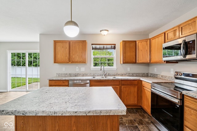 1739 Wedgewood Pl, Avon, IN 46123 - kitchen featuring stainless steel appliances, plenty of natural light, light countertops, and a center island