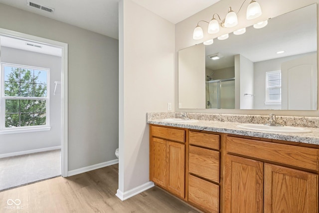 1739 Wedgewood Pl, Avon, IN 46123 - bathroom featuring double vanity, a stall shower, and wood finished floors