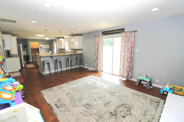 3119 W Burning Tree Rd, Crawfordsville, IN 47933 - living room featuring dark wood-type flooring, baseboards, and recessed lighting