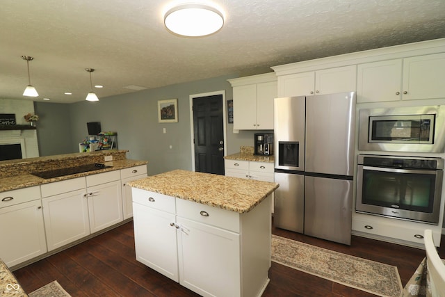 3119 W Burning Tree Rd, Crawfordsville, IN 47933 - kitchen featuring appliances with stainless steel finishes, dark wood finished floors, white cabinetry, hanging light fixtures, and light stone countertops