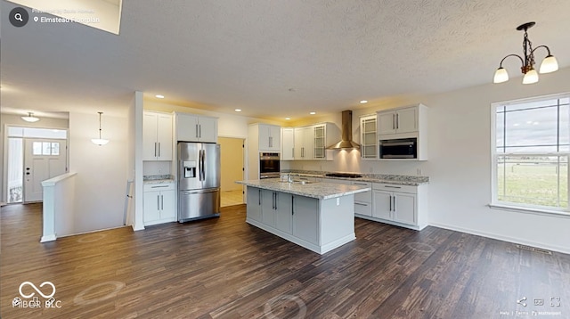 4995 S 650 W, Jamestown, IN 46147 - kitchen featuring appliances with stainless steel finishes, wall chimney range hood, dark wood-style floors, a textured ceiling, and a center island with sink