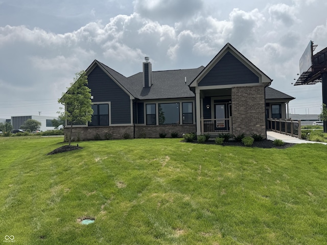 4995 S 650 W, Jamestown, IN 46147 - back of house featuring brick siding, a chimney, a yard, and covered porch