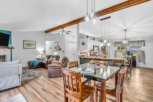 101 Jefferson Vly, Coatesville, IN 46121 - dining space featuring a ceiling fan, light wood finished floors, and a brick fireplace