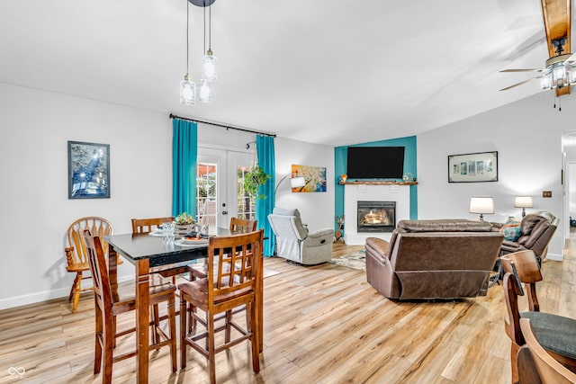 101 Jefferson Vly, Coatesville, IN 46121 - dining area featuring a ceiling fan, french doors, light wood finished floors, a glass covered fireplace, and lofted ceiling