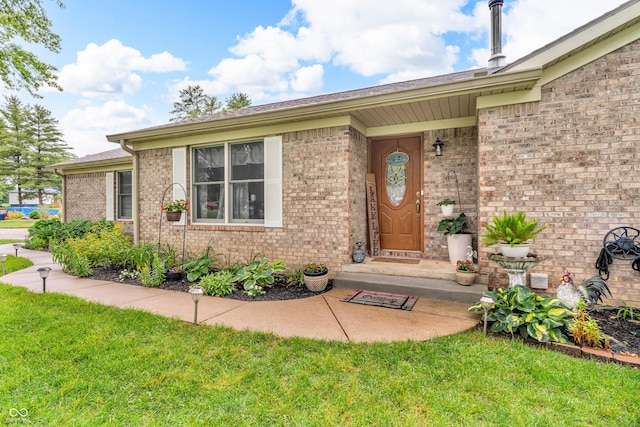 101 Jefferson Vly, Coatesville, IN 46121 - view of exterior entry featuring brick siding and a lawn