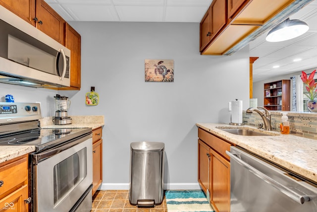 101 Jefferson Vly, Coatesville, IN 46121 - kitchen with stainless steel appliances, a drop ceiling, brown cabinets, backsplash, and light stone counters