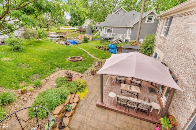 101 Jefferson Vly, Coatesville, IN 46121 - view of grassy yard featuring a wooden deck, a fire pit, a gazebo, and a patio