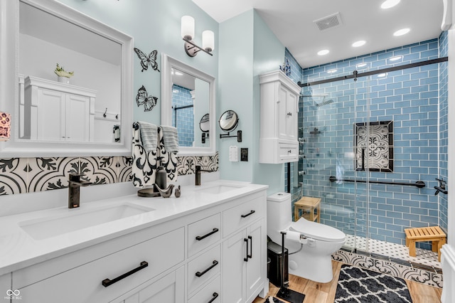 101 Jefferson Vly, Coatesville, IN 46121 - full bathroom with wood finished floors, a stall shower, double vanity, backsplash, and recessed lighting