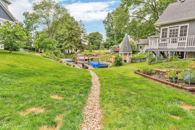 101 Jefferson Vly, Coatesville, IN 46121 - view of grassy yard featuring a vegetable garden, a deck, and a gazebo