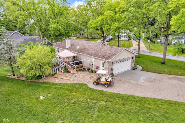 101 Jefferson Vly, Coatesville, IN 46121 - view of front of house featuring an attached garage, a front yard, driveway, brick siding, and a wooden deck