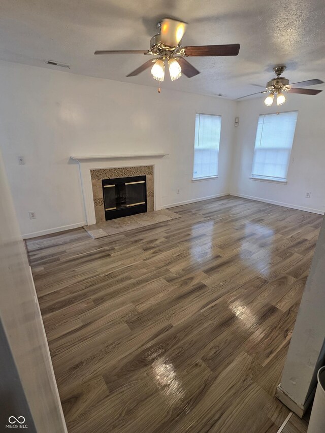6368 Titania Dr, Indianapolis, IN 46236 - unfurnished living room featuring a ceiling fan, wood finished floors, a fireplace, and baseboards