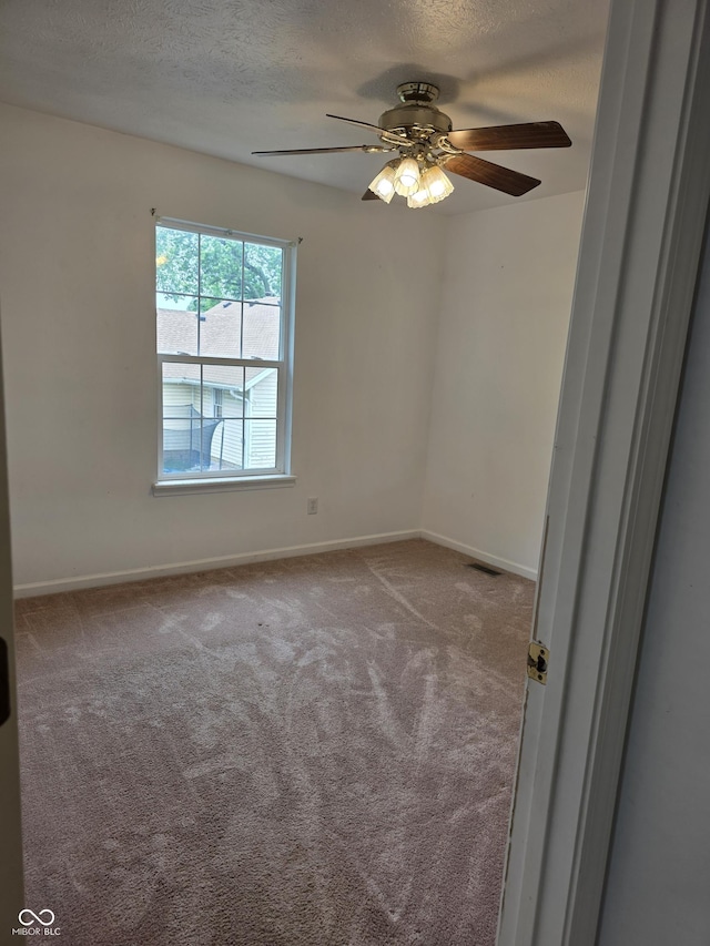 6368 Titania Dr, Indianapolis, IN 46236 - carpeted spare room with a textured ceiling, a ceiling fan, and baseboards