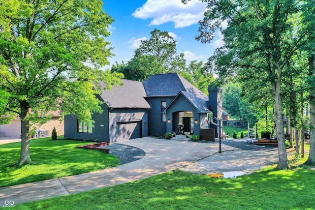 826 N Lanyard Dr, Cicero, IN 46034 - view of front of home with concrete driveway, a chimney, a garage, a front lawn, and roof with shingles