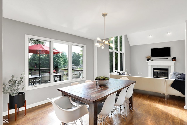 826 N Lanyard Dr, Cicero, IN 46034 - dining area featuring wood finished floors, a fireplace, a chandelier, and baseboards