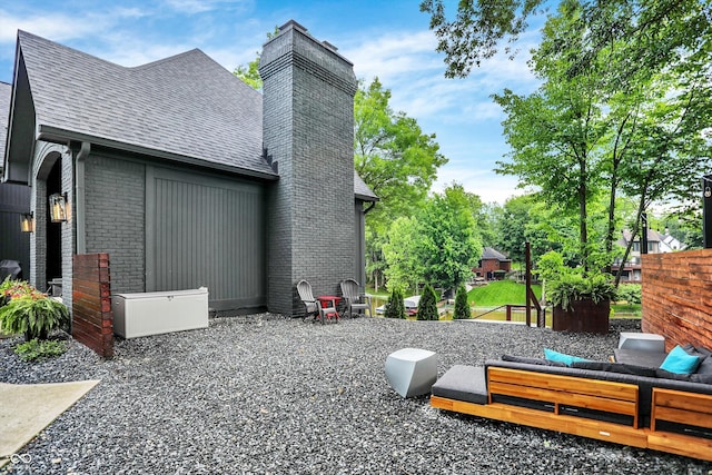 826 N Lanyard Dr, Cicero, IN 46034 - view of side of home with a chimney, roof with shingles, and brick siding