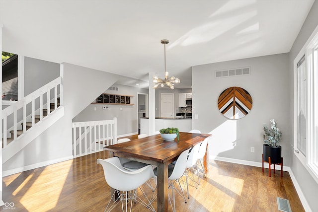 826 N Lanyard Dr, Cicero, IN 46034 - dining space featuring wood finished floors, a chandelier, baseboards, and stairway