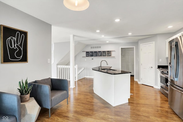 826 N Lanyard Dr, Cicero, IN 46034 - kitchen with a sink, dark countertops, appliances with stainless steel finishes, recessed lighting, and wood finished floors