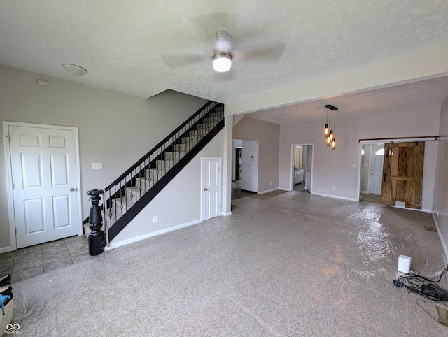 301 W Davis St, Greensburg, IN 47240 - unfurnished living room featuring stairway, baseboards, ceiling fan, and a textured ceiling