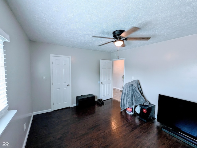301 W Davis St, Greensburg, IN 47240 - unfurnished bedroom with wood finished floors, a textured ceiling, baseboards, and a ceiling fan