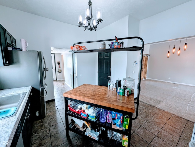 301 W Davis St, Greensburg, IN 47240 - kitchen with a chandelier, baseboards, a sink, freestanding refrigerator, and decorative light fixtures