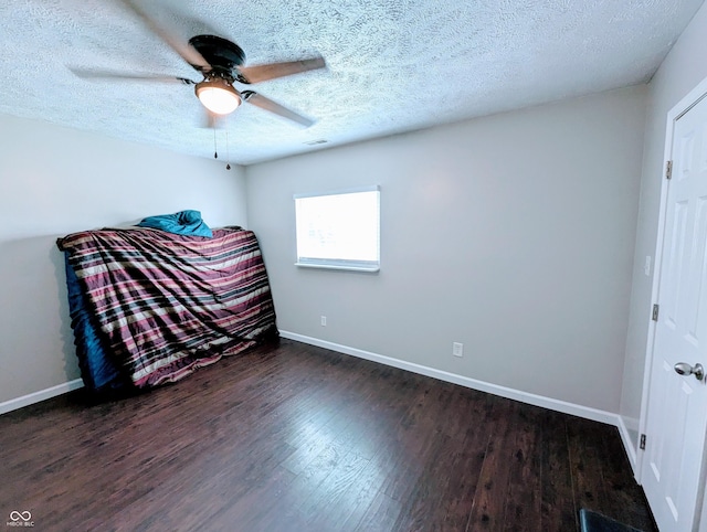 301 W Davis St, Greensburg, IN 47240 - bedroom featuring dark wood-style flooring, baseboards, a textured ceiling, and a ceiling fan