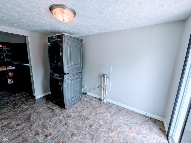 301 W Davis St, Greensburg, IN 47240 - laundry room featuring stacked washer / dryer, a textured ceiling, and baseboards